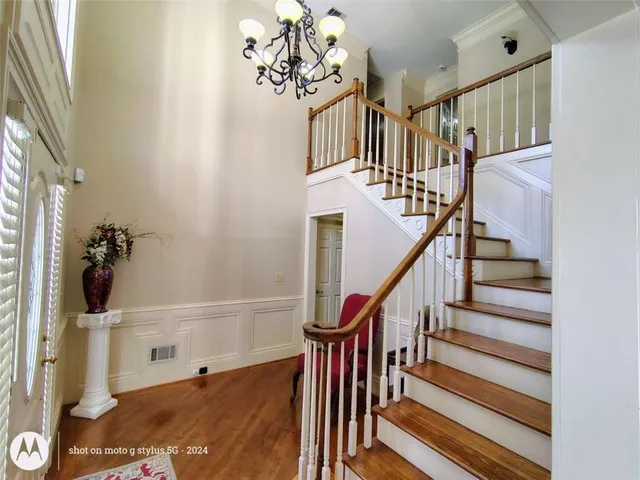 a view of entryway and hall with wooden floor