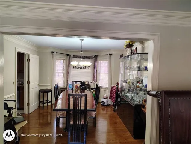 a view of a dining room with furniture and window