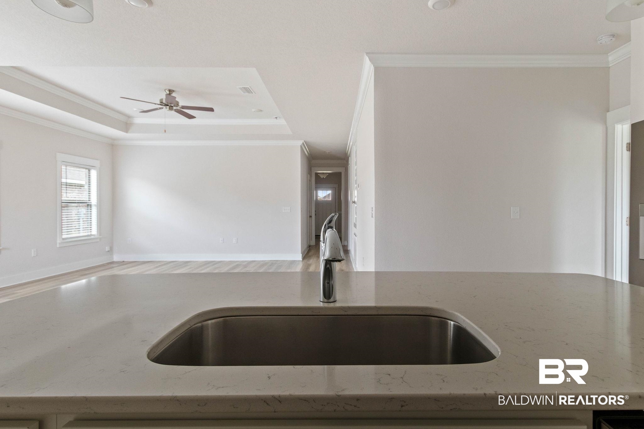1710 Grouse Street Foley, AL 36535 - Photo 29 of 76 Kitchen island featuring an undermount stainless steel sink and a contemporary faucet