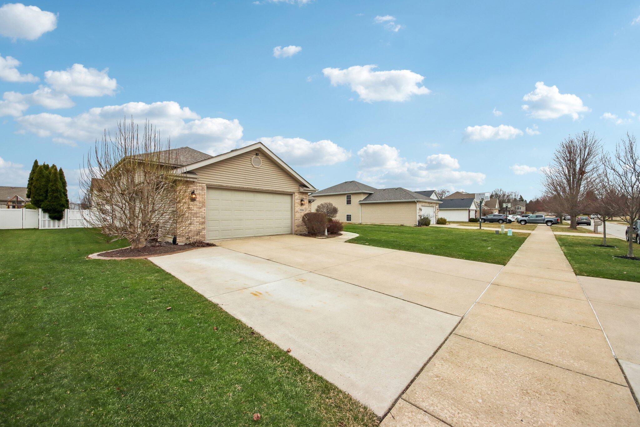 9396 Calumet Street Dyer, IN 46311 - Photo 2 of 43 a front view of a house with garden