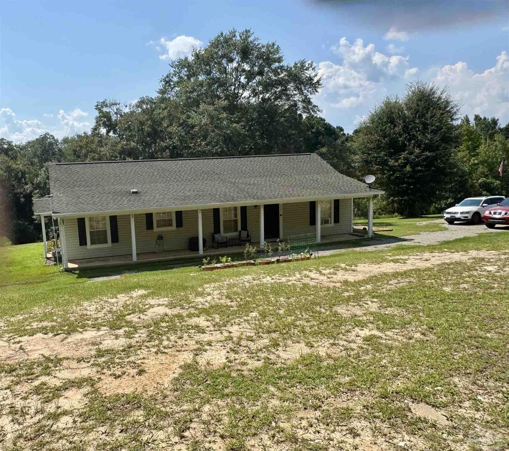 a front view of a house with a garden