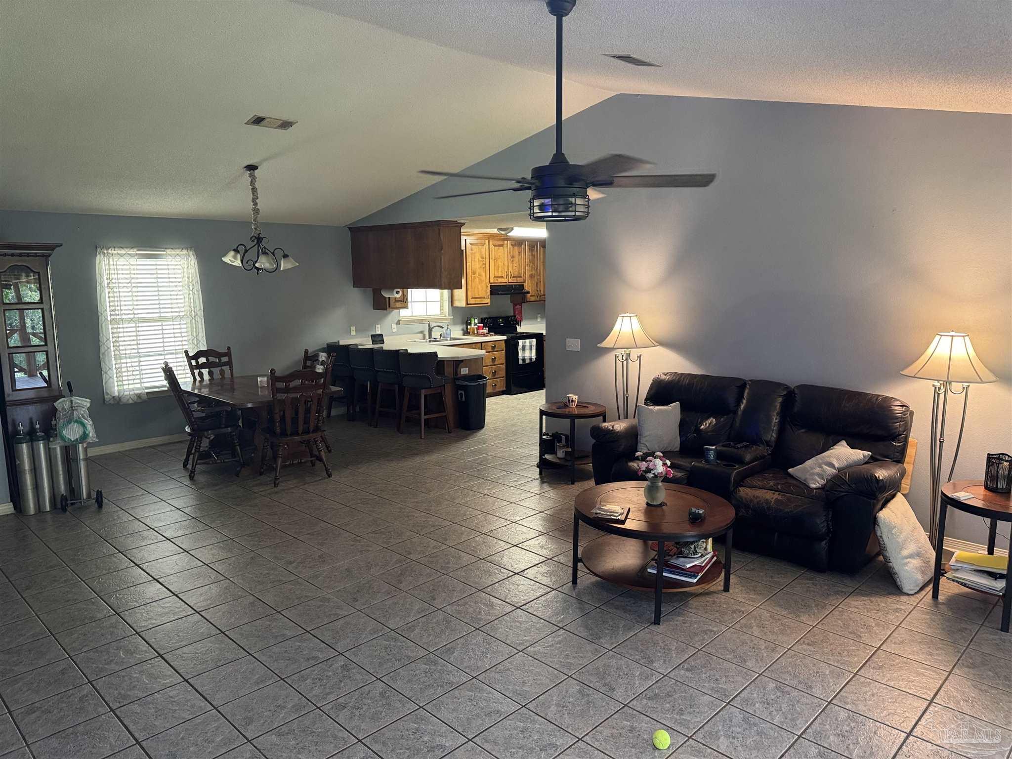 7551 McElhaney Road Century, FL 32535 - Photo 14 of 43 a living room with furniture and a chandelier