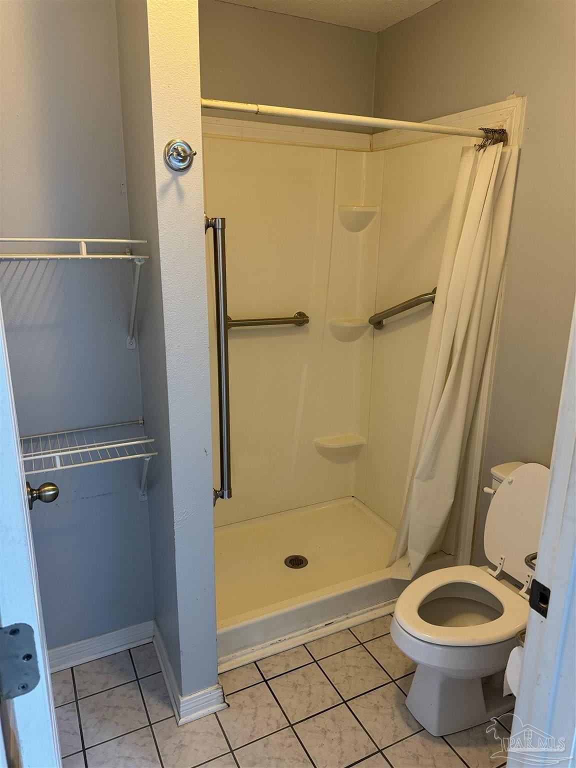 7551 McElhaney Road Century, FL 32535 - Photo 23 of 43 a bathroom with a granite countertop toilet and a shower