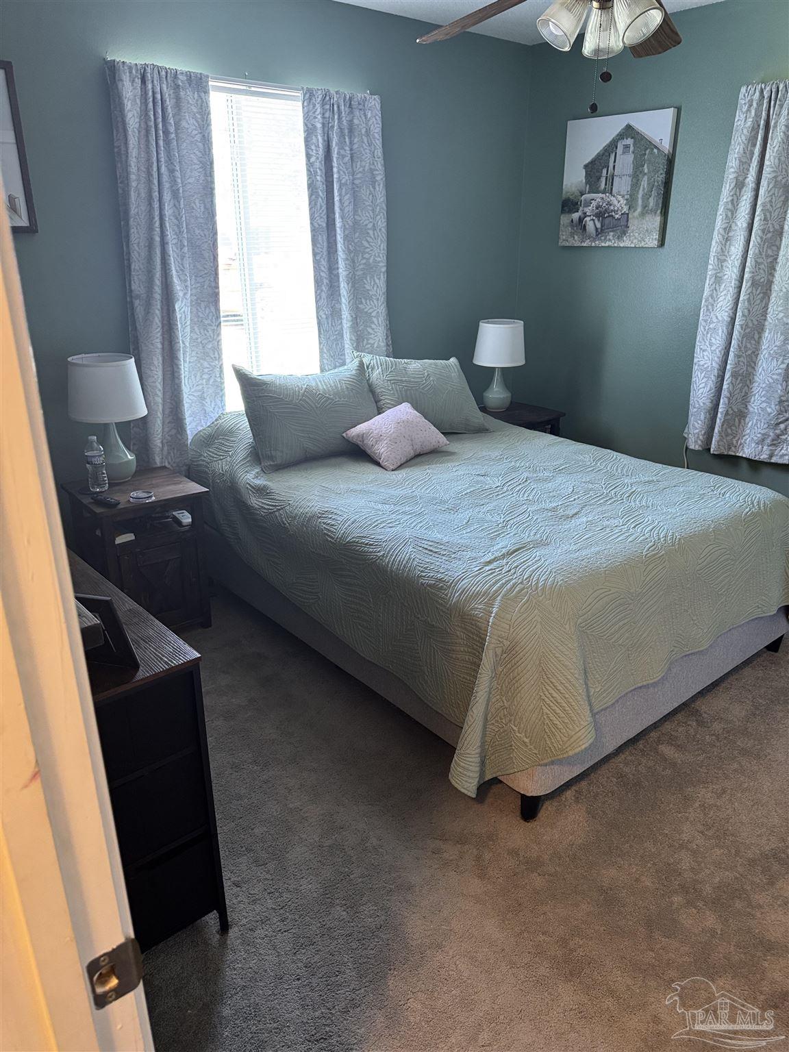 7551 McElhaney Road Century, FL 32535 - Photo 30 of 43 a bedroom with a bed and a window