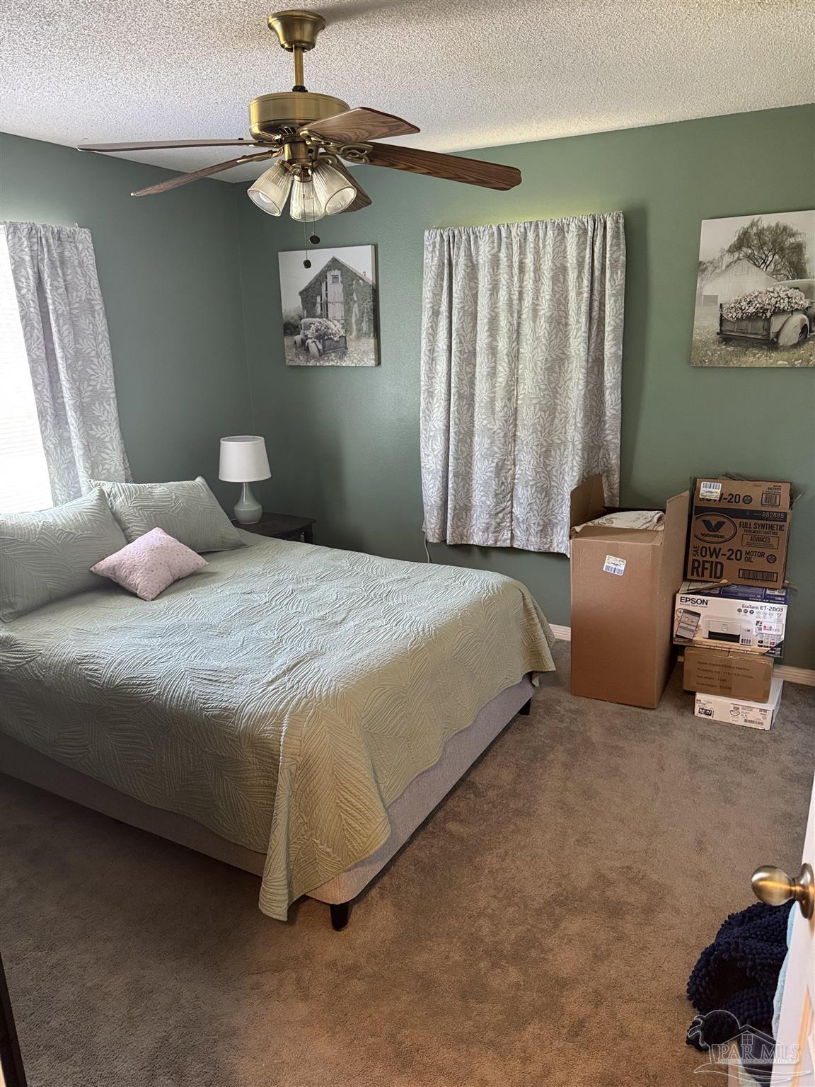 7551 McElhaney Road Century, FL 32535 - Photo 31 of 43 a bedroom with a bed and a chandelier