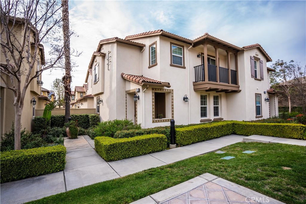 8090 Cornwall Court, Unit 31 Rancho Cucamonga, CA 91739 - Photo 1 of 1 a front view of a house with a yard