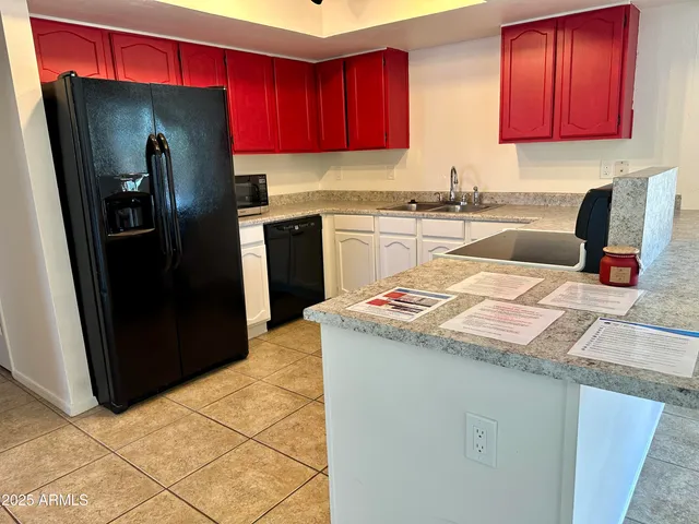 a kitchen with stainless steel appliances granite countertop a refrigerator sink and stove
