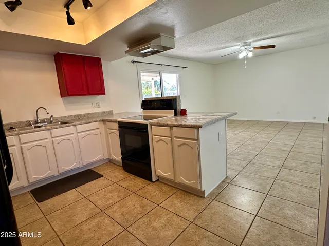 a kitchen with a sink cabinets and window