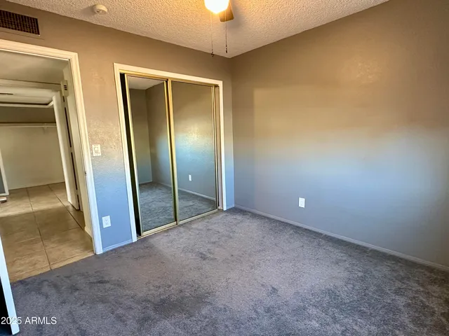 an empty room with a mirror and a shower