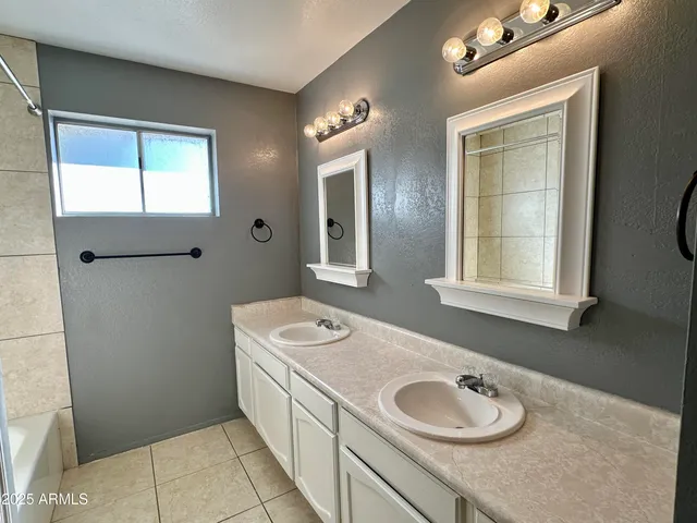 a bathroom with a tub a toilet and sink