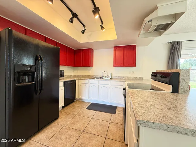 a kitchen with stainless steel appliances granite countertop a refrigerator and a stove