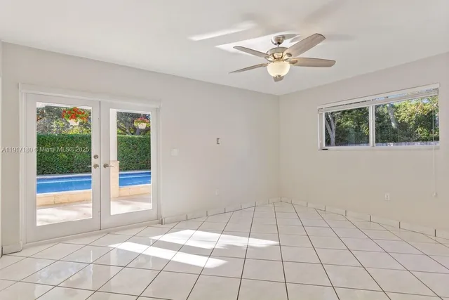 a view of an entryway with a chandelier fan