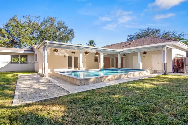 a view of house with yard and entertaining space