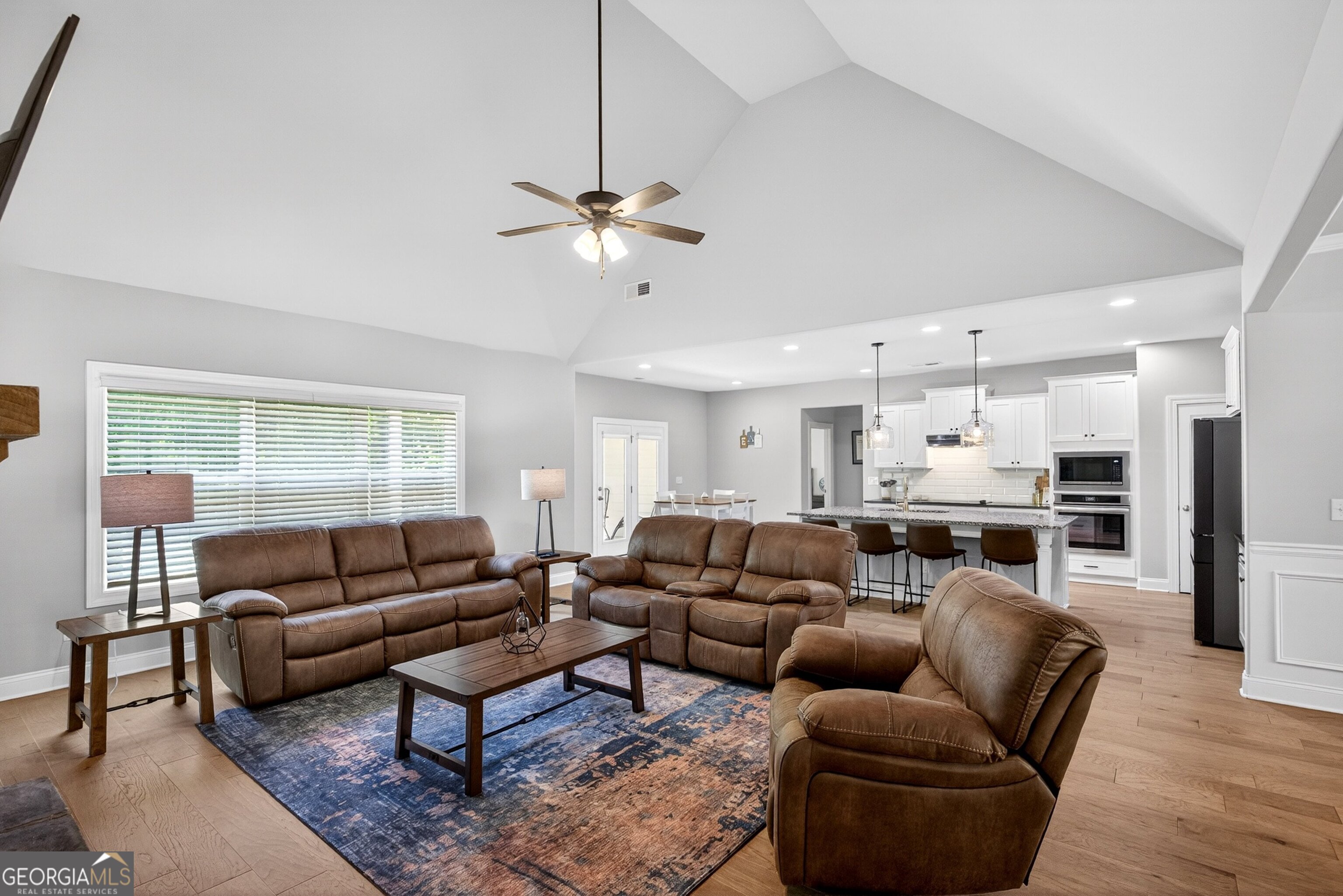 1764 Luther Bailey Road Senoia, GA 30276 - Photo 2 of 63 a living room with furniture kitchen view and a chandelier