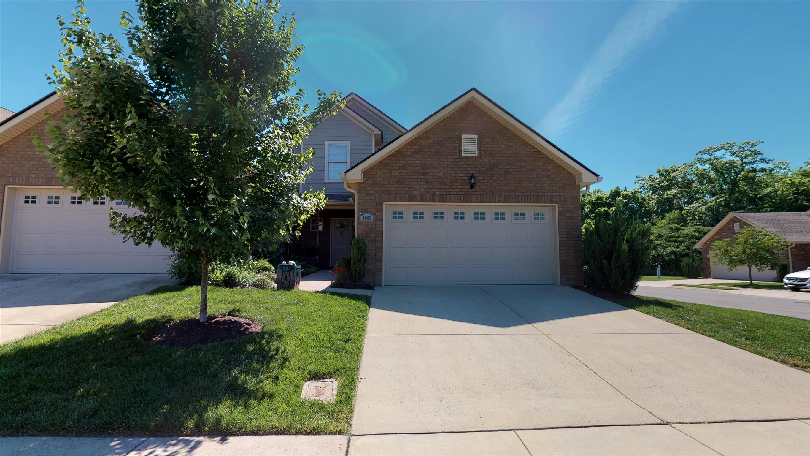 1065 Irish Way Spring Hill, TN 37174 - Photo 1 of 28 a front view of a house with a yard and garage