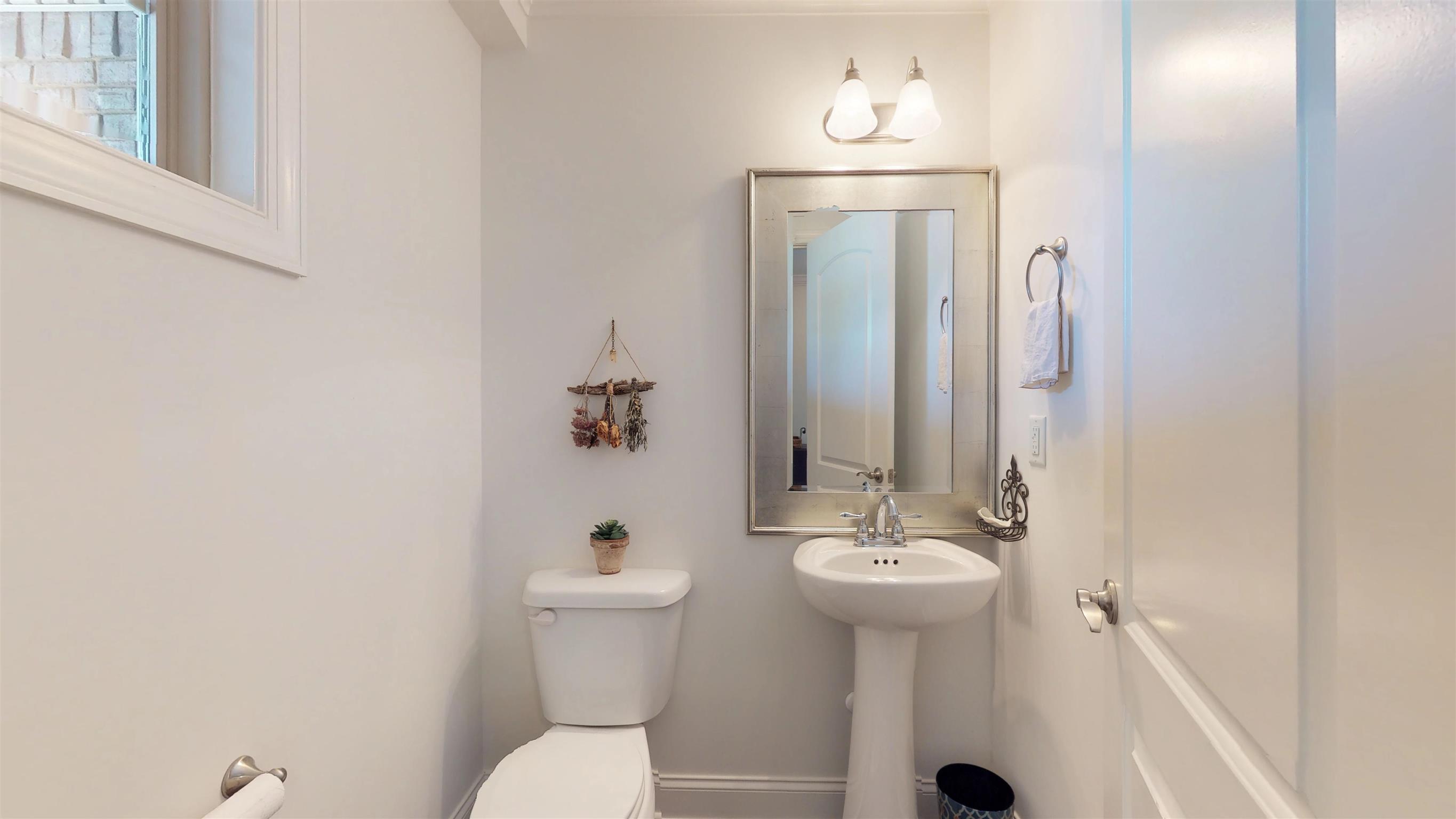 1065 Irish Way Spring Hill, TN 37174 - Photo 4 of 28 a bathroom with a sink a toilet and mirror