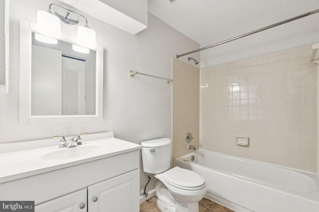 a bathroom with a sink toilet vanity and shower