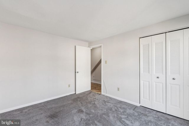 an empty room with sliding door and view of bedroom