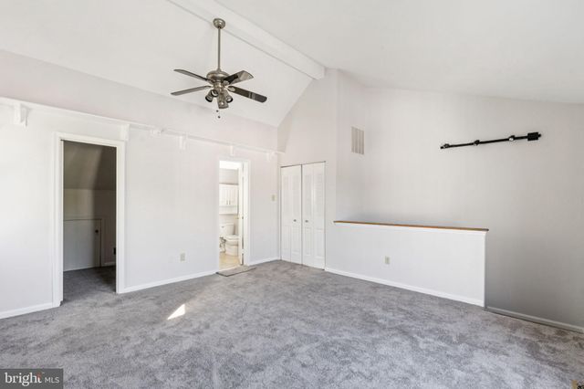 a view of a livingroom with a ceiling fan and window