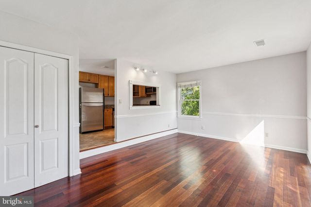a view of a kitchen with wooden floor and electronic appliances