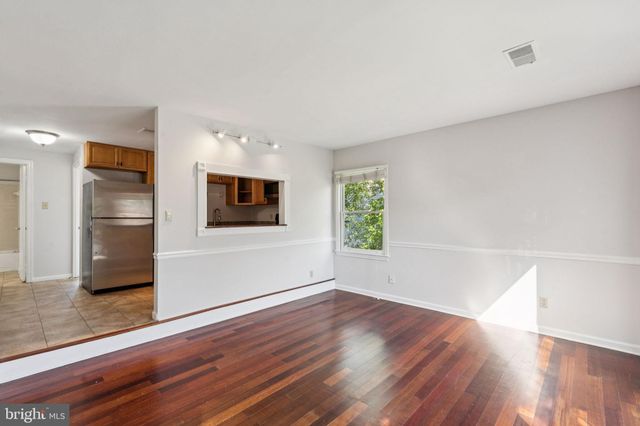 a view of a kitchen with wooden floor and electronic appliances