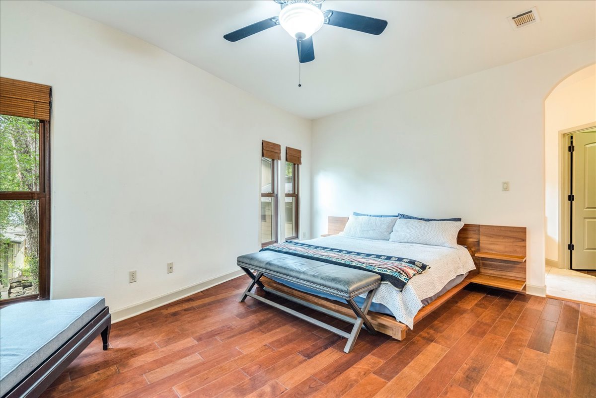 3012 South 4th Street, Unit B Austin, TX 78704 - Photo 13 of 40 Spacious room featuring wood-finish flooring, white walls, and multiple windows with wood blinds