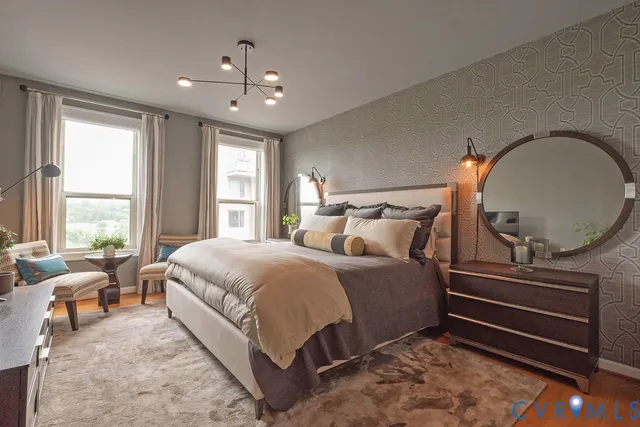 a bedroom with double bed and a chandelier