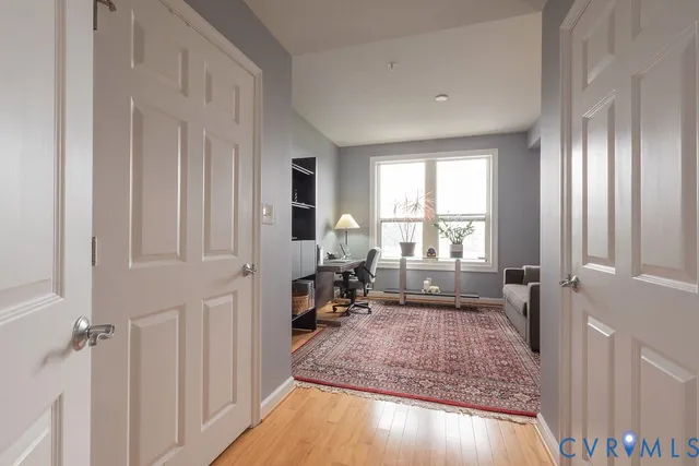a living room with furniture a flat screen tv and a large window