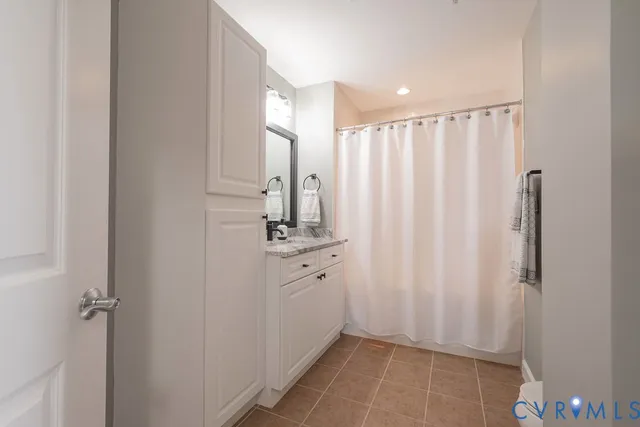 a bathroom with a granite countertop sink a mirror a shower and a bathtub