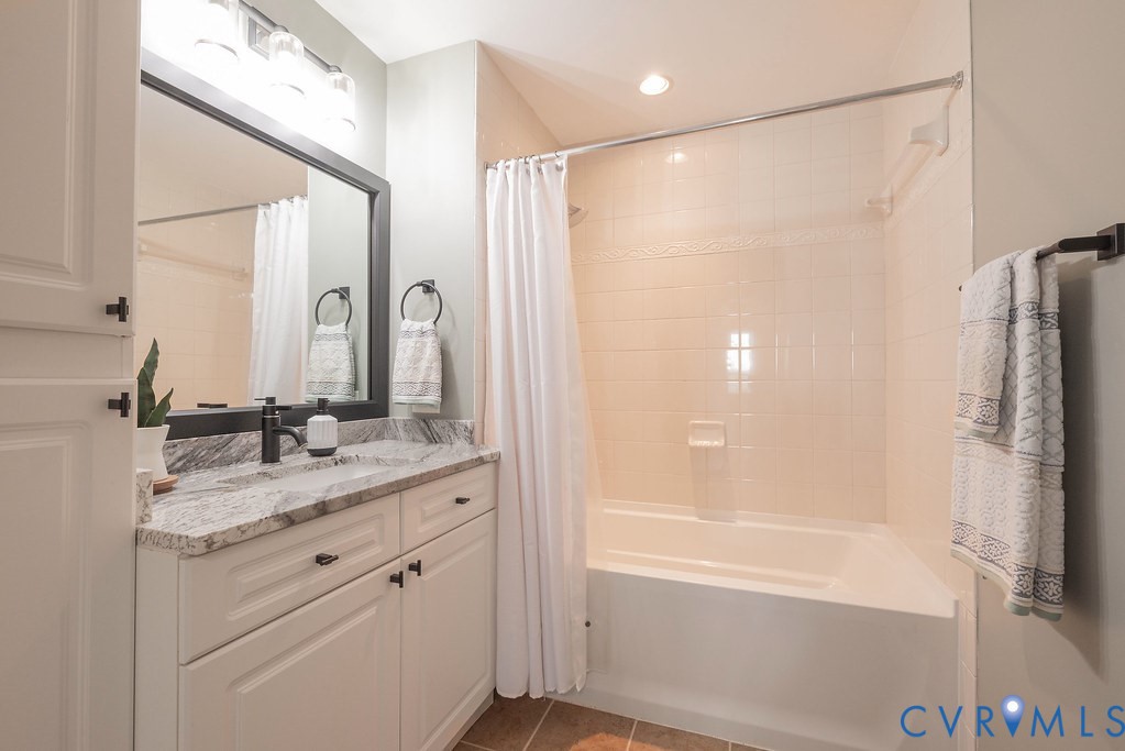 4820 Old Main Street, Unit 511 Henrico, VA 23231 - Photo 38 of 51 a bathroom with a granite countertop sink a mirror a shower and a bathtub