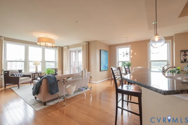 a kitchen with stainless steel appliances kitchen island granite countertop a table and chairs in it