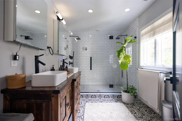 a bathroom with a sink a toilet and shower