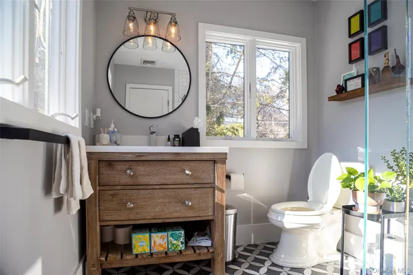 a bathroom with a toilet a sink and a mirror