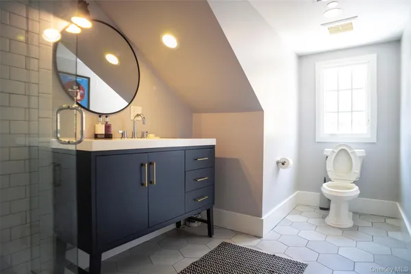 a bathroom with a toilet sink and mirror