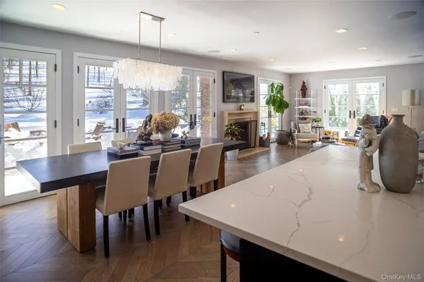 a living room with furniture dining table and a large window