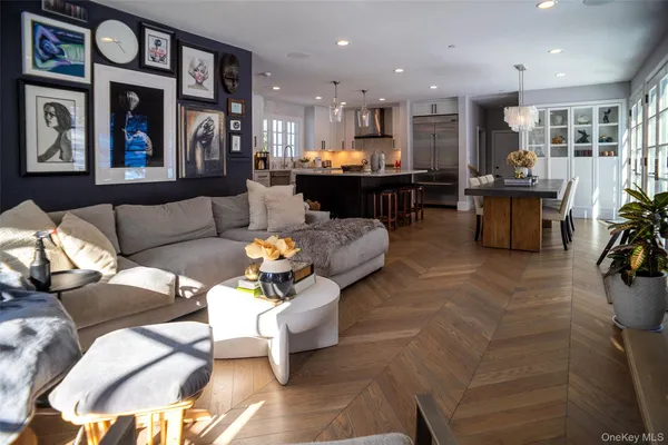 a living room with furniture and kitchen view