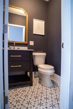 a bathroom with a toilet a sink and a mirror