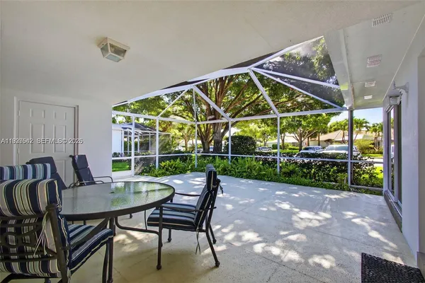 a view of a patio with a table chairs and a backyard