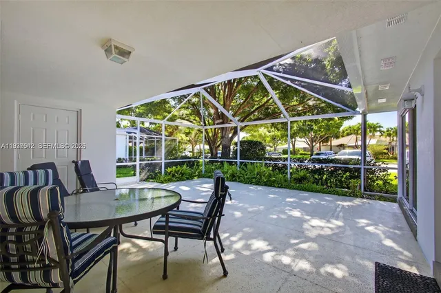 a view of a patio with a table chairs and a backyard