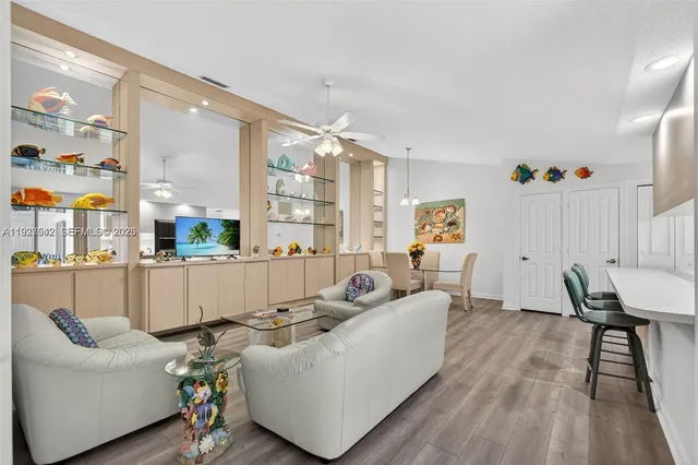 a living room with furniture and wooden floor