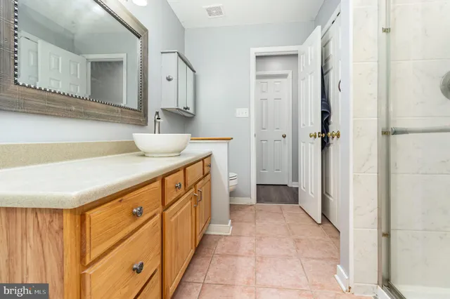 a bathroom with a sink a mirror and a shower