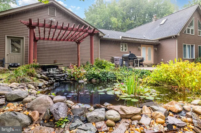 a front view of a house with a yard and outdoor seating