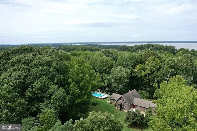 an aerial view of a house with lots of trees