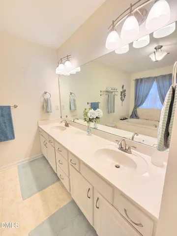 a bathroom with a double vanity sink and a mirror