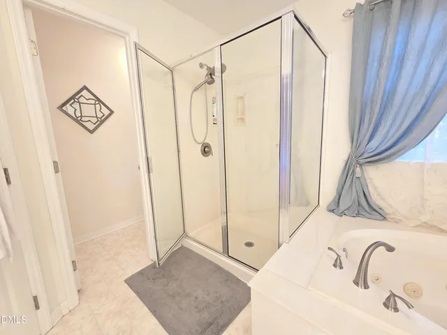 a bathroom with a shower and a sink