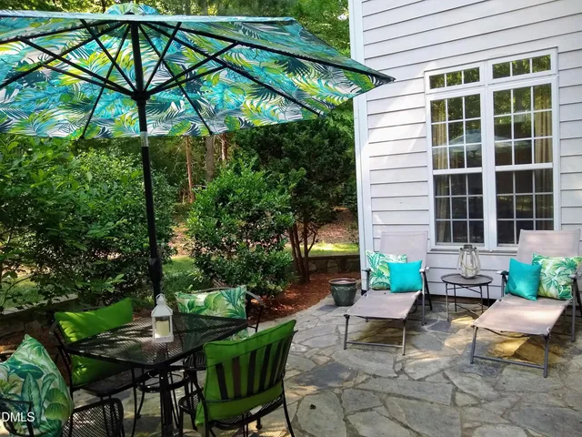 a view of a patio with table and chairs and potted plants