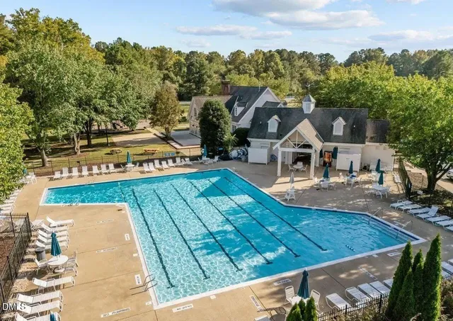 a view of a swimming pool with an outdoor seating and a garden
