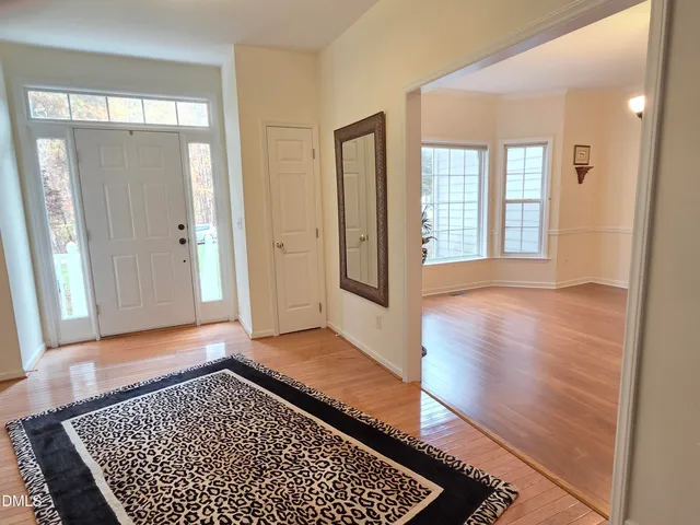 a view of a room with wooden floor and windows