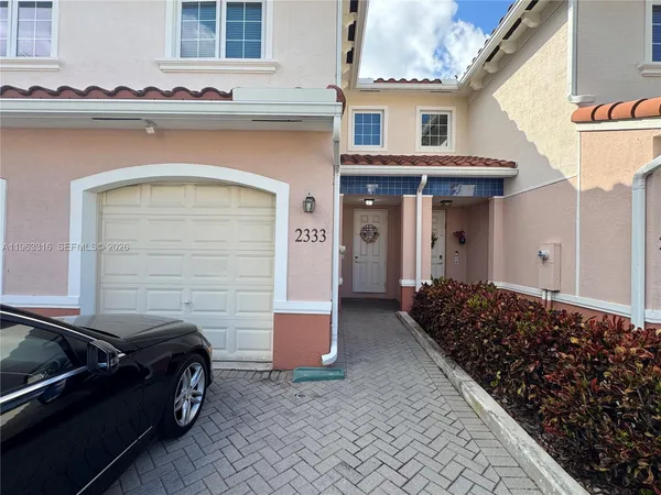 a view of a car park in front of house