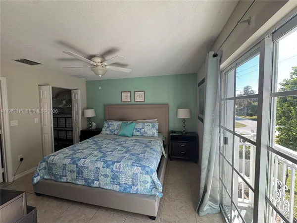 a bedroom with a large bed and a window